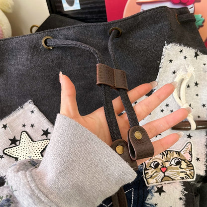 Black and white Washed Canvas Drawstring Backpack with Distressed Star Patches