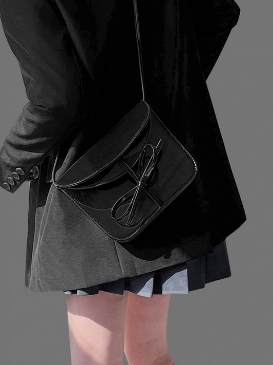 Elegant Black Crossbody Phone Pouch With Glossy Finish And Bow Accent